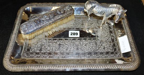 Silver hand brush, a model of a zebra and a tray
